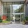Large glass entrance with plants on the side